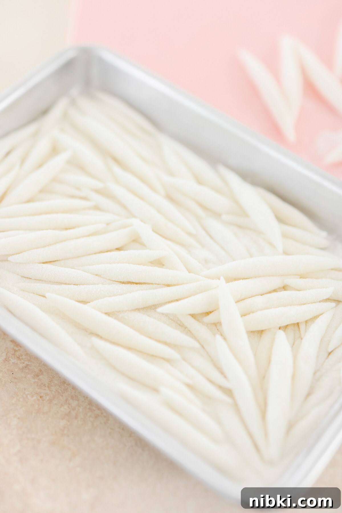 silver pin noodles on a baking tray