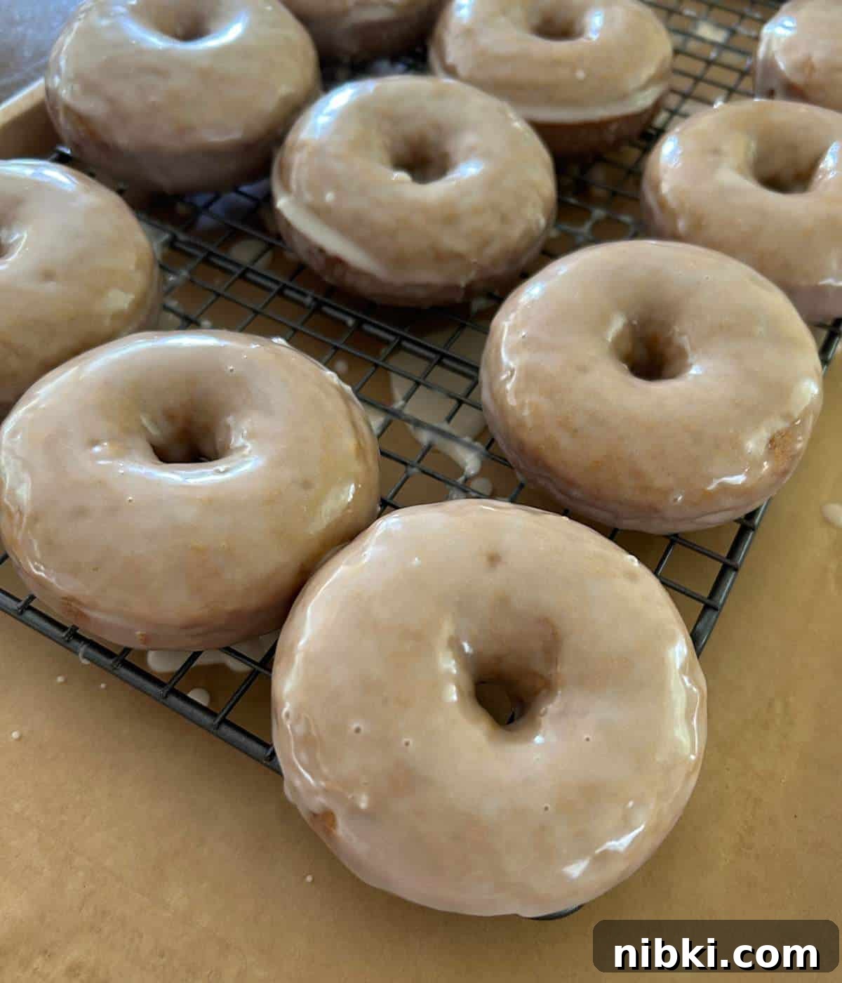 Glazed donuts hardening on rack.
