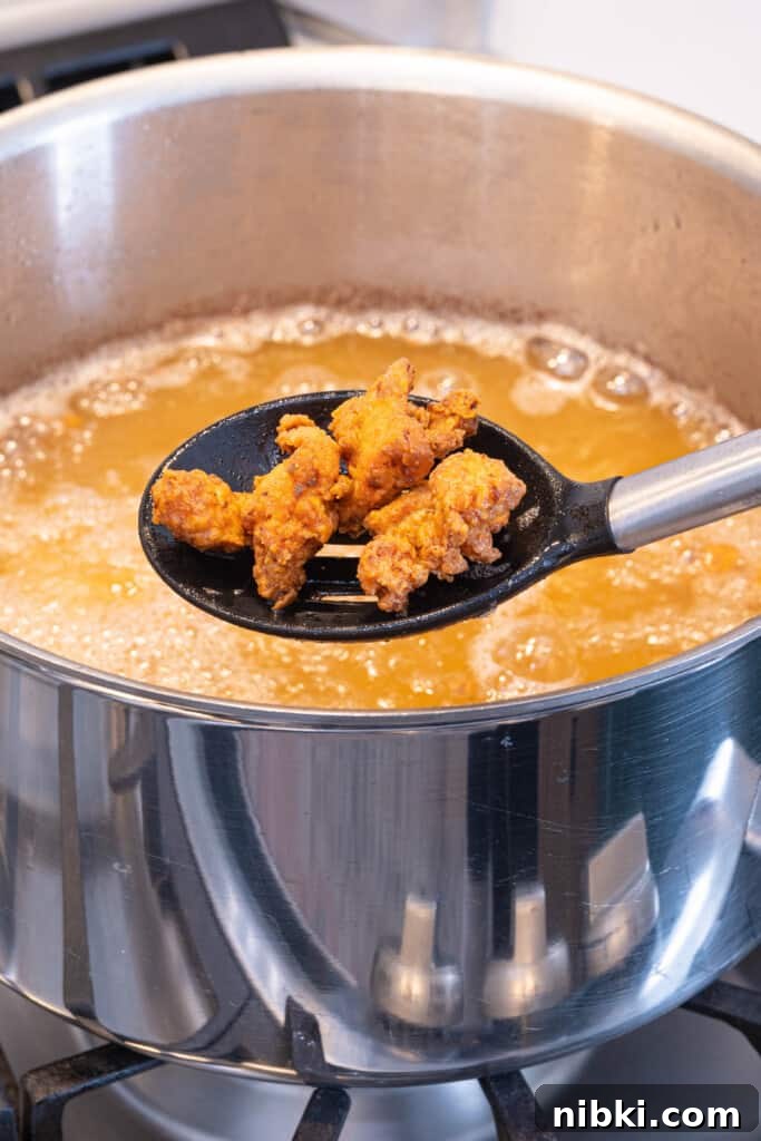 Crispy Puerto Rican Chicken Chicharrones 6 fried chicken coming out of a frying pan
