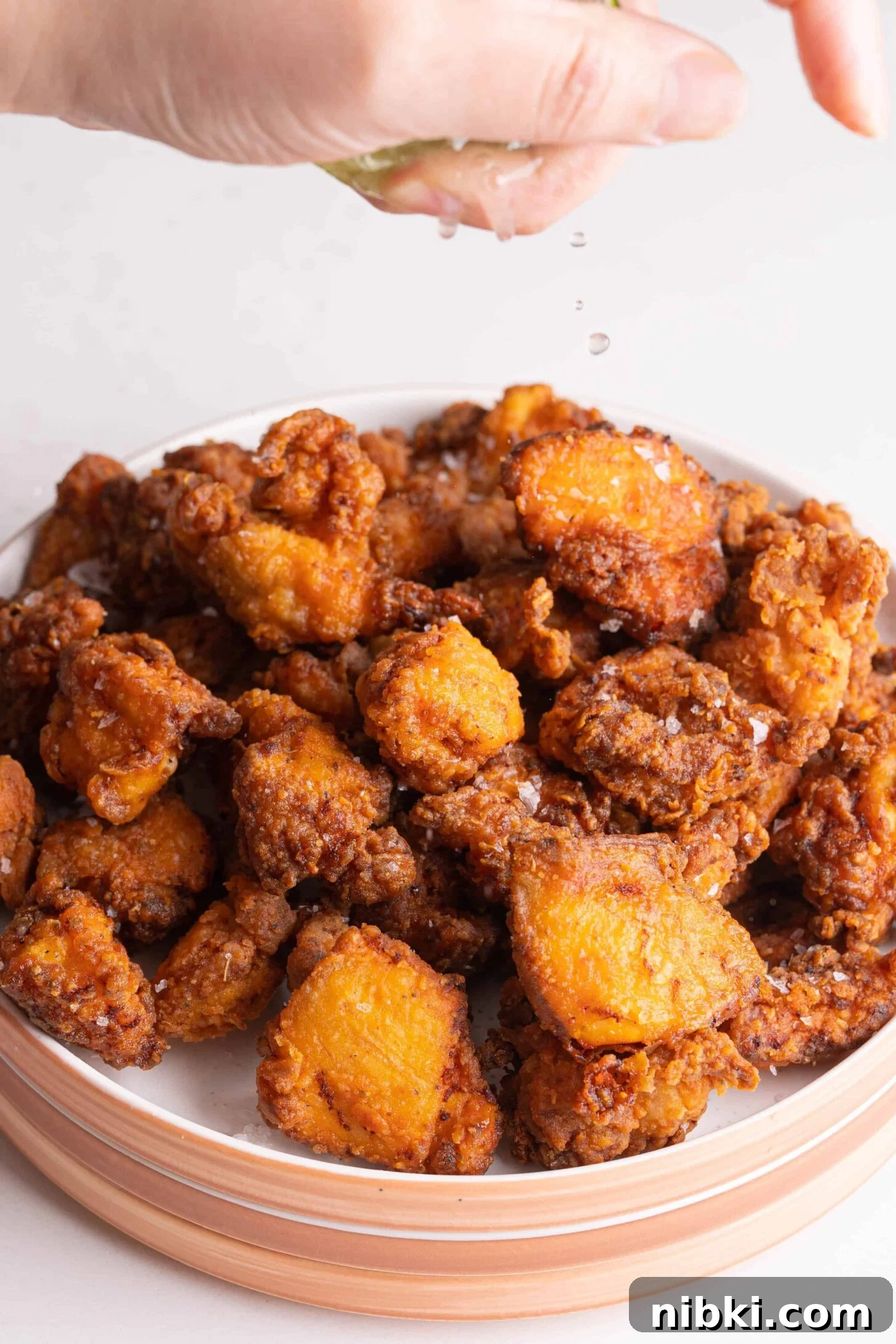 Crispy Puerto Rican Chicken Chicharrones 8 lime squeezing over Puerto Rican fried chicken
