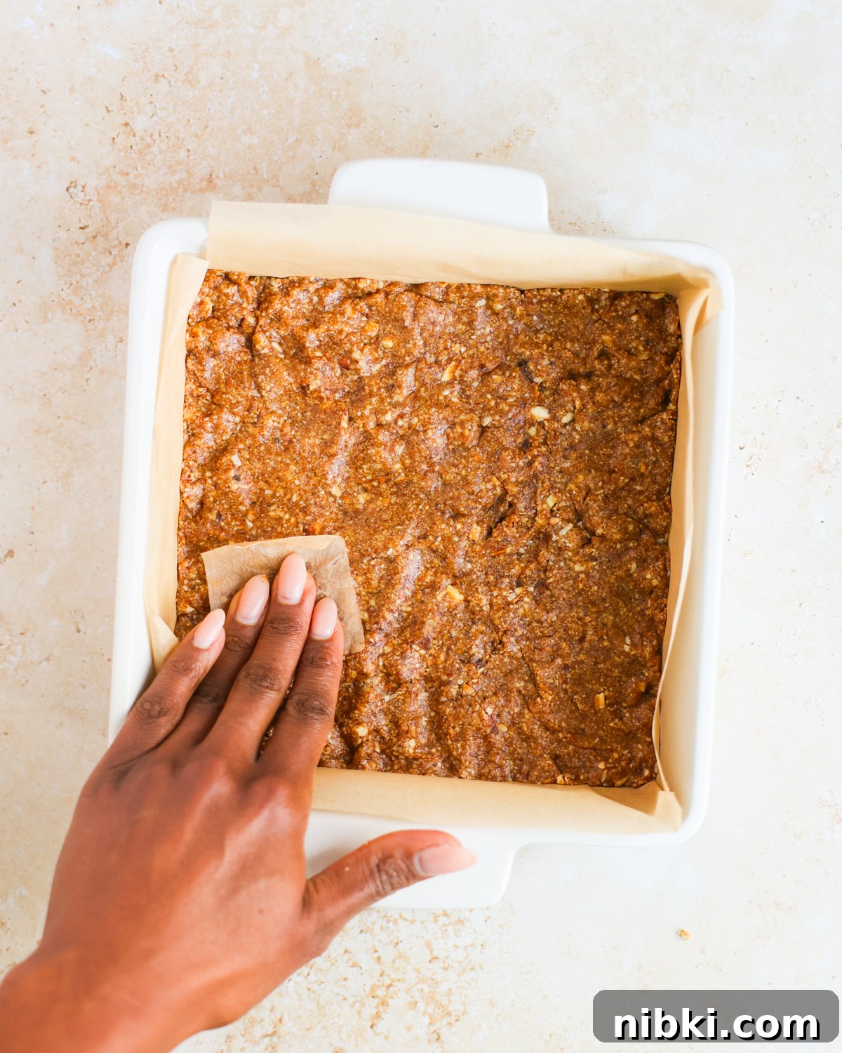 overhead pressing gingerbread crust in tray