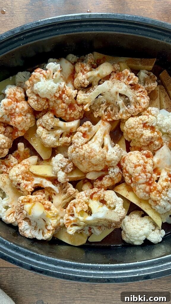 Greek braised cauliflower in a roasting pan with potatoes.