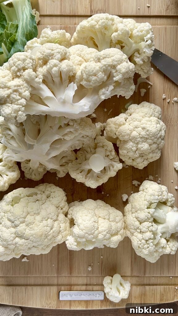 Cutting cauliflower into large florets.