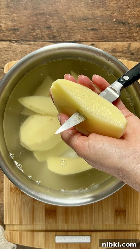 Cutting potatoes in wedges.