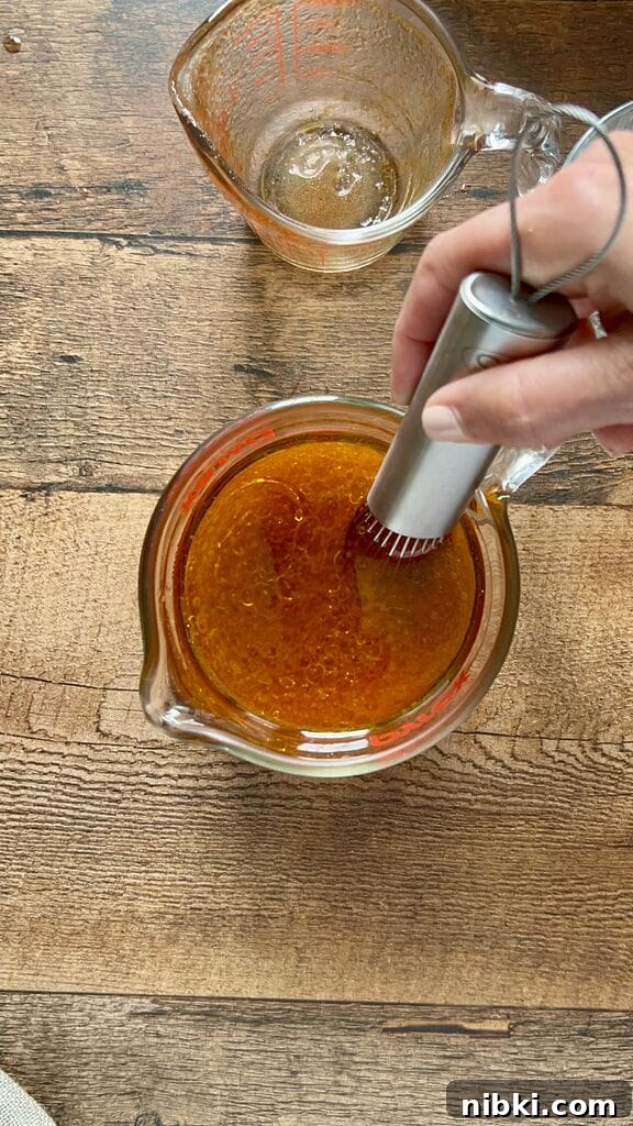 Combining the tomato sauce, olive oil and water.