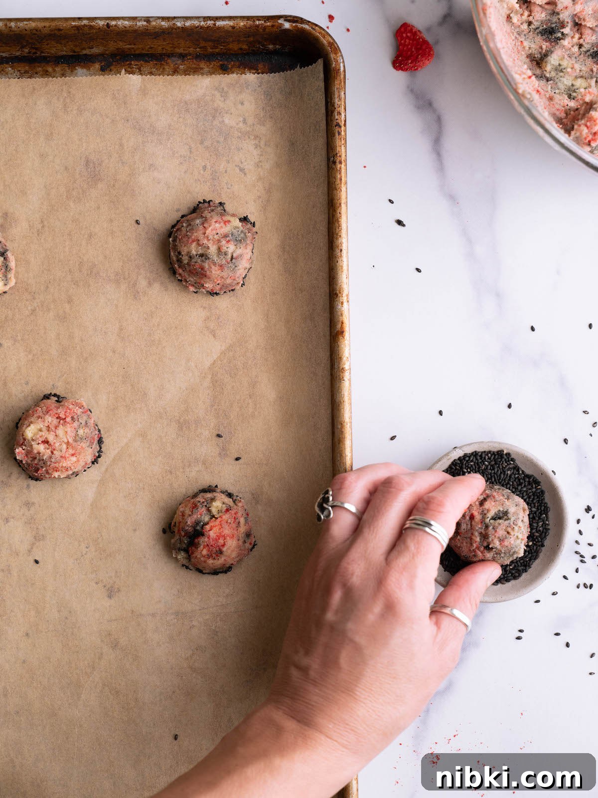Strawberry and Black Sesame Cookie Recipe 5 Dipping strawberry swirl cookies into black sesame seeds