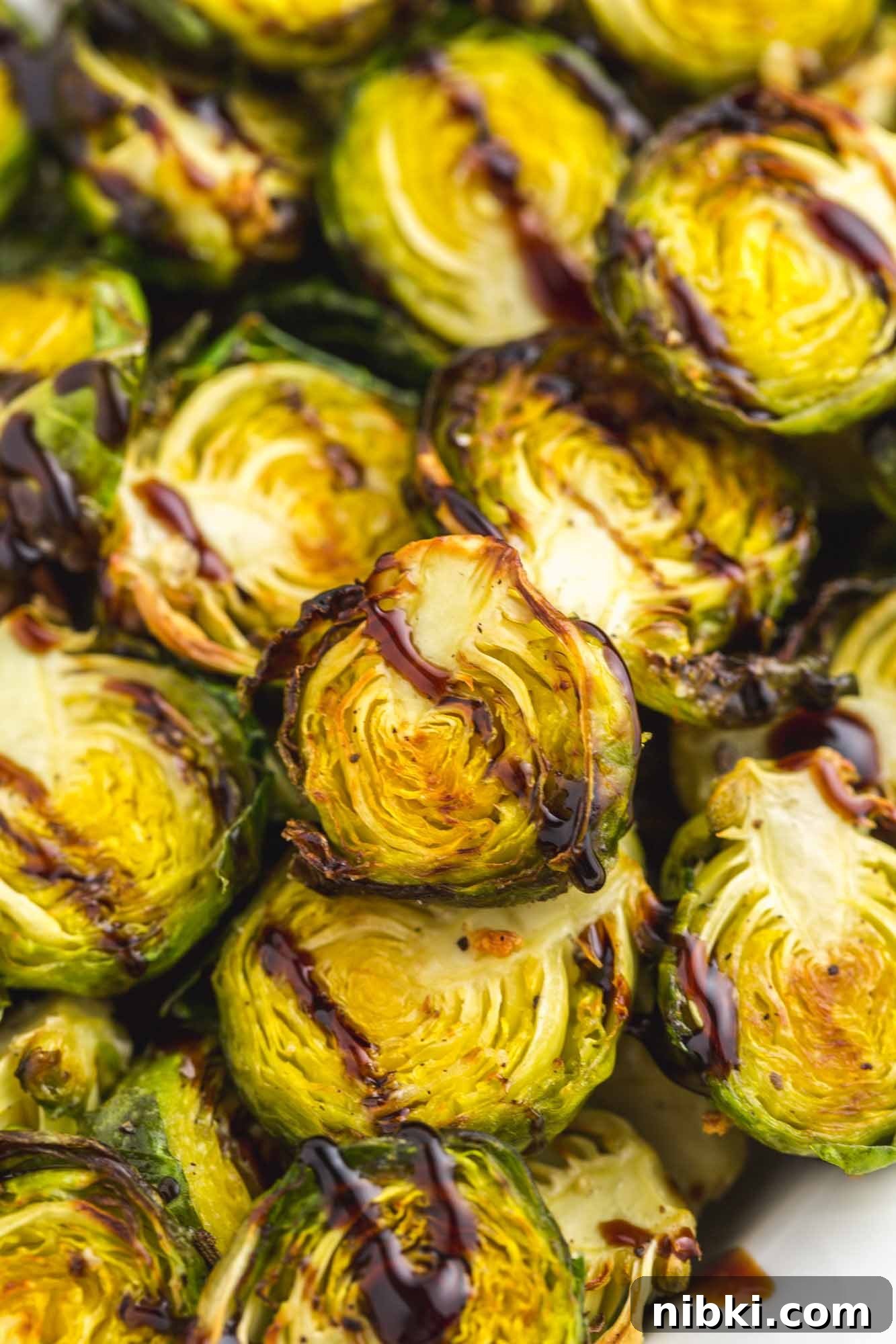 Crispy Air Fryer Brussels Sprouts with Garlic Parmesan 2 Close up shot of Air Fried brussels sprouts and balsamic glaze