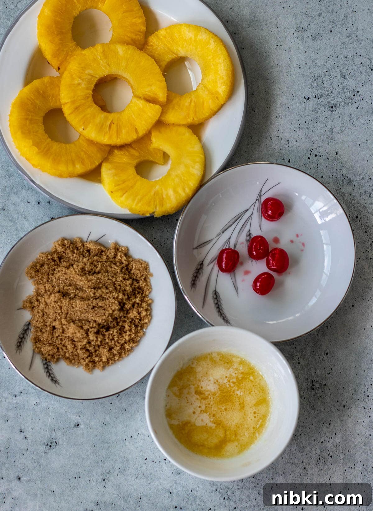 Moist Pineapple Upside-Down Pound Cake Recipe 4 Pineapple rings, maraschino cherries, brown sugar, and melted butter.