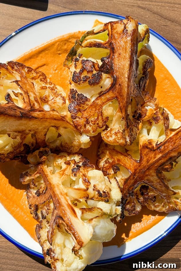 Pan-roasted cauliflower wedges on a bed of romesco sauce