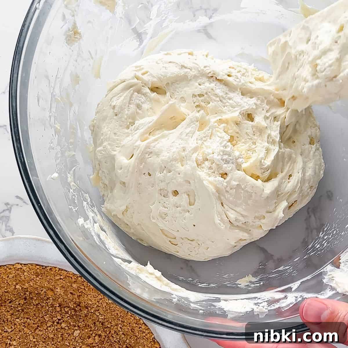 No-Bake Cream Cheese Pie Recipe 6 Folding in cool whip.