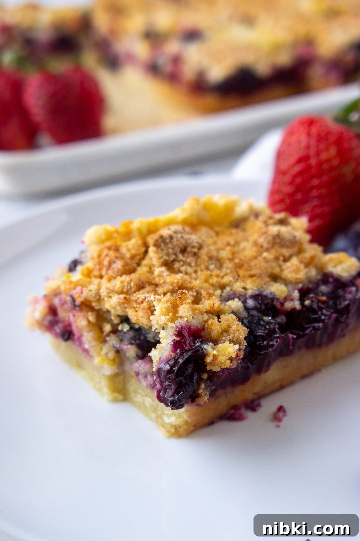 Mixed Berry Crumble Bars Recipe with Oat Streusel 2 Berry crumble bars on a plate