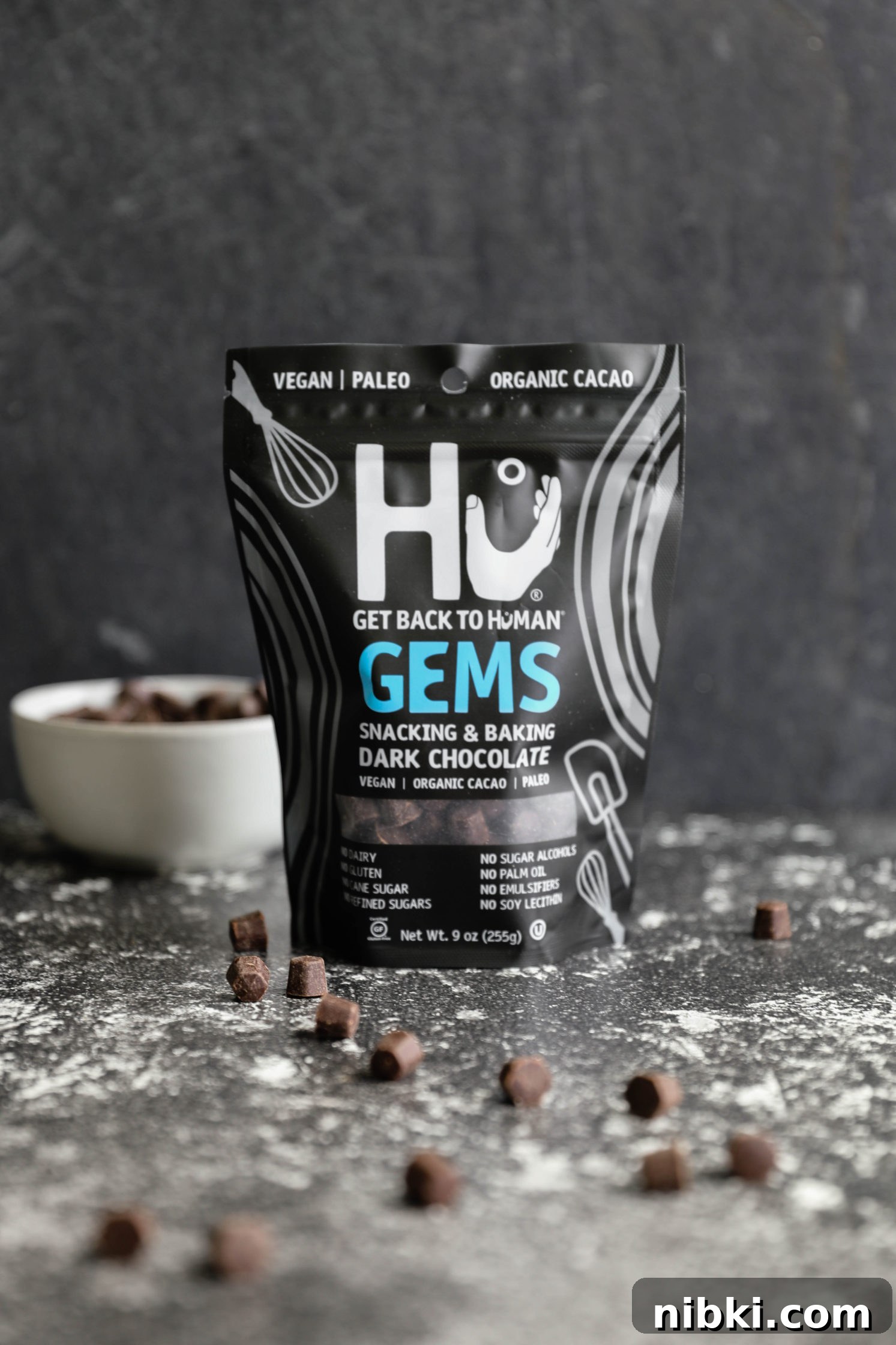 No-Bake Edible Vegan Cookie Dough Recipe 2 Hu Kitchen Gems on black board with bowl and scattered chocolate pieces