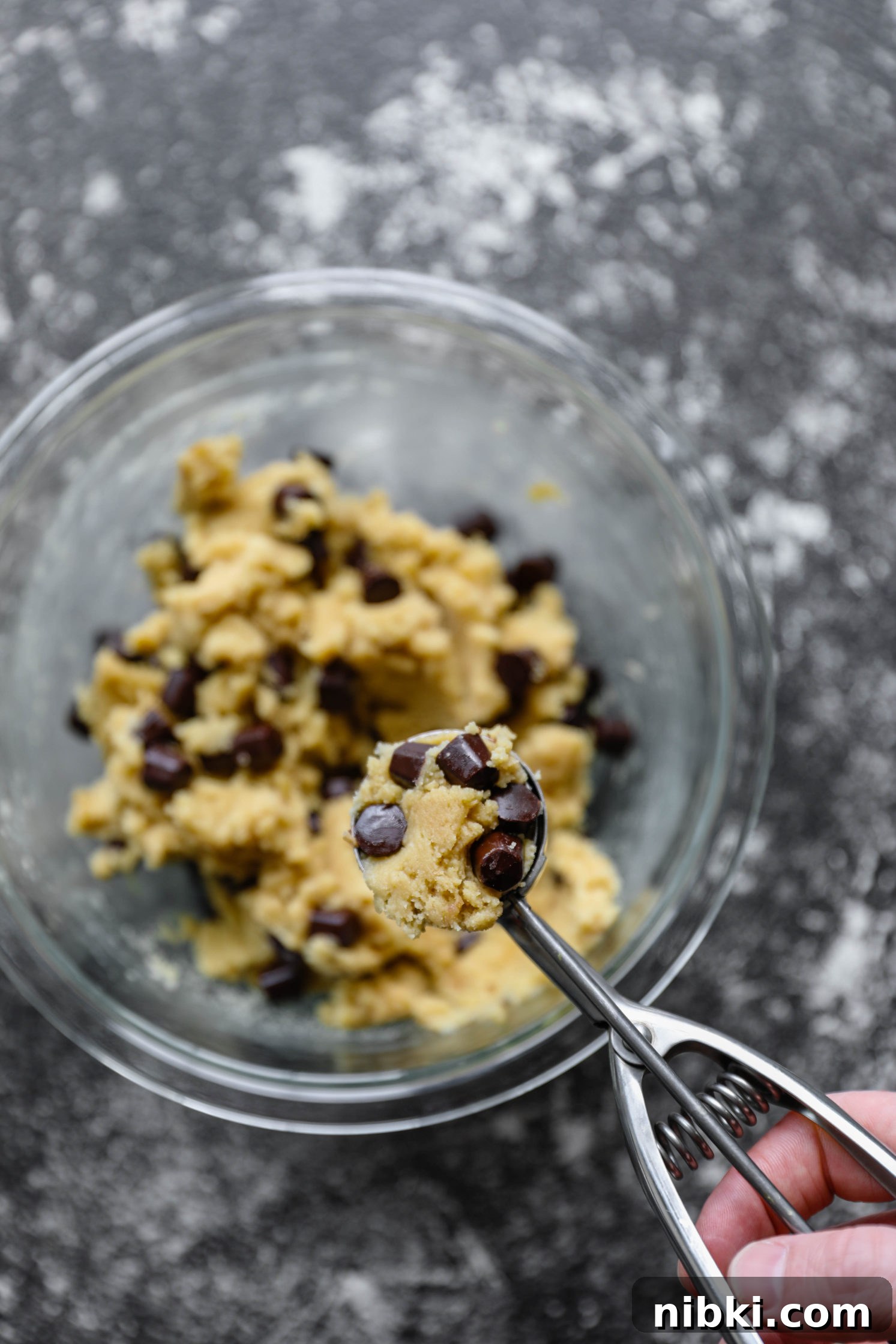 No-Bake Edible Vegan Cookie Dough Recipe 4 hand scooping Edible Vegan Cookie Dough with a cookie scoop