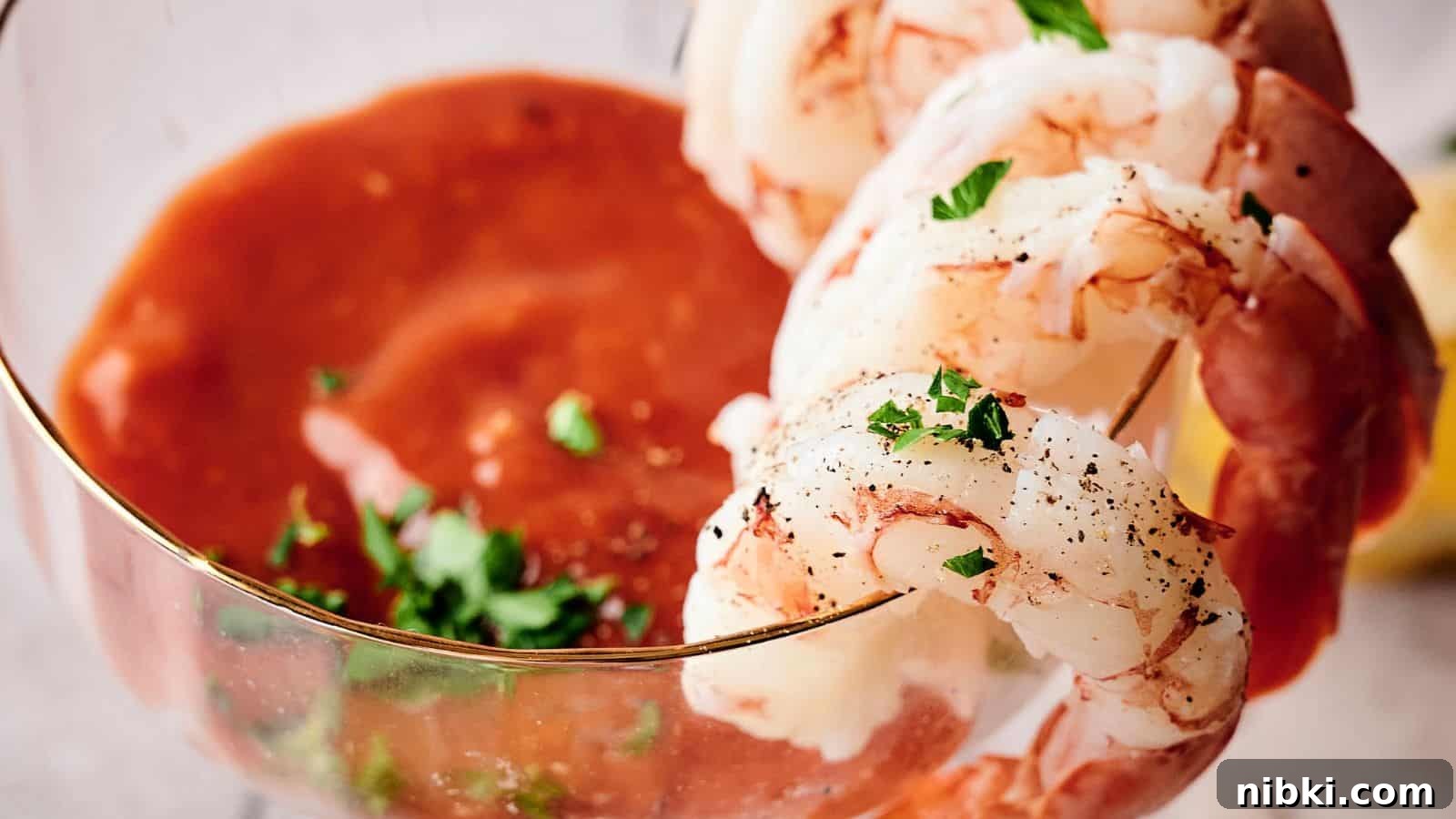 33 Christmas Potluck Recipes to Bring December Magic 5 Shrimp cocktail with peeled shrimp arranged on the rim of a glass filled with cocktail sauce, garnished with parsley.
