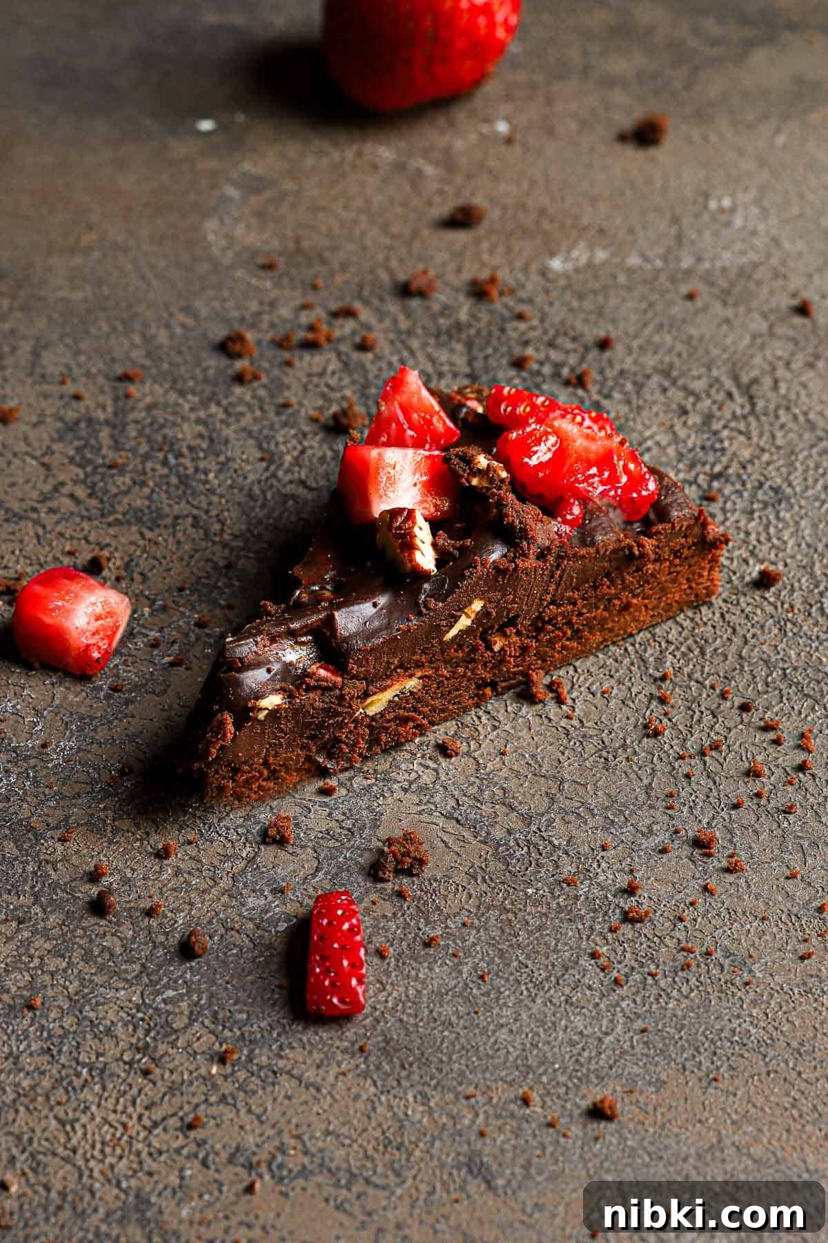 How to Make Brownie Pizza: Chocolate Dessert Pizza Recipe 3 A slice of brownie topped with ganache and fresh strawberries.