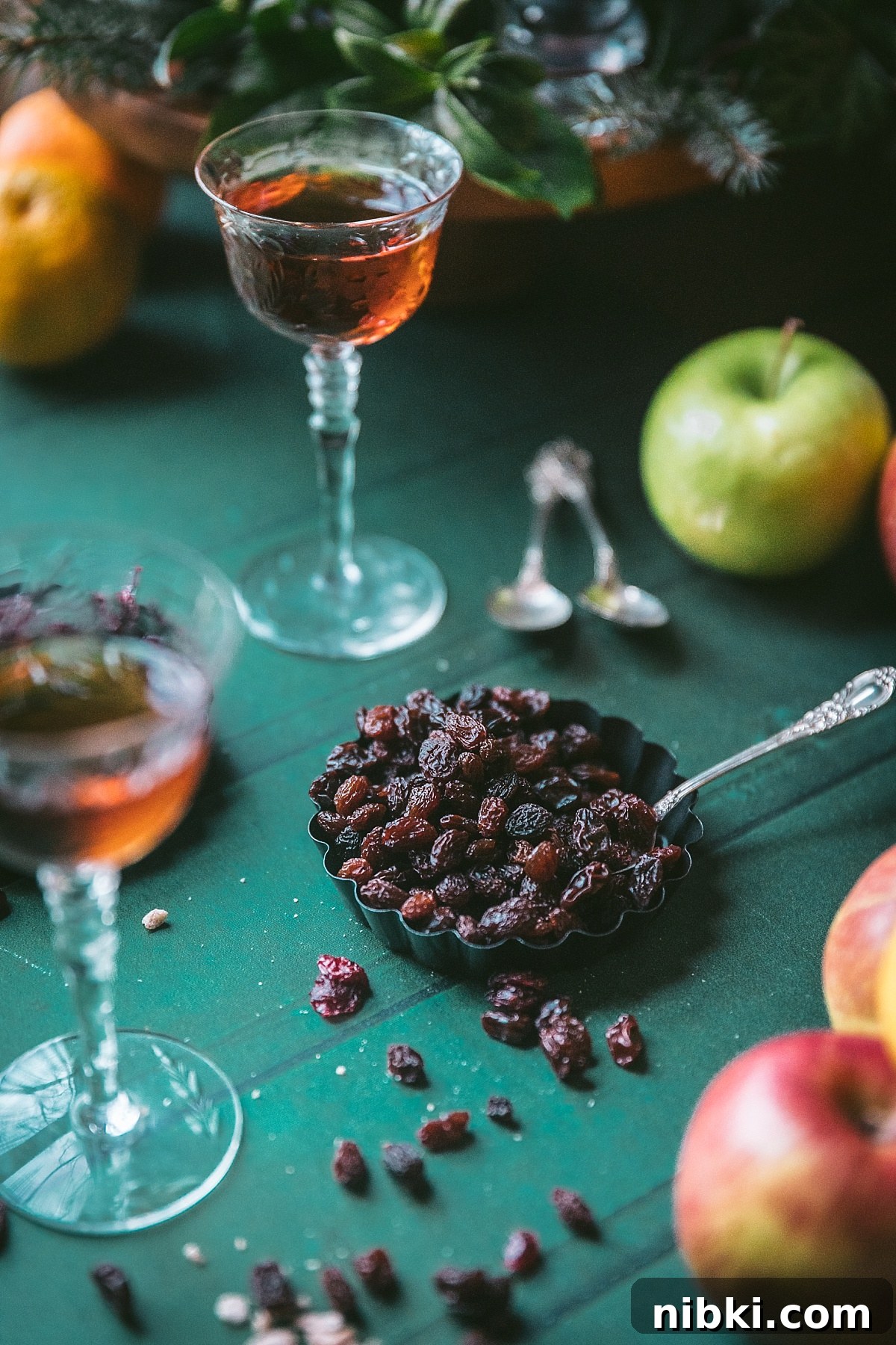 raisins for mincemeat tarts in mini tart pans with apples oranges and grand marnier around