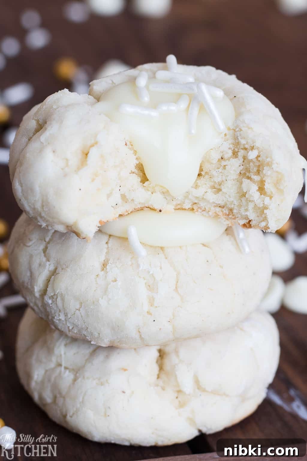 White Chocolate Thumbprint Cookies Recipe with Raspberry Jam 4 A White Chocolate Thumbprint Cookie split open to show the soft, tender cream cheese cookie inside.