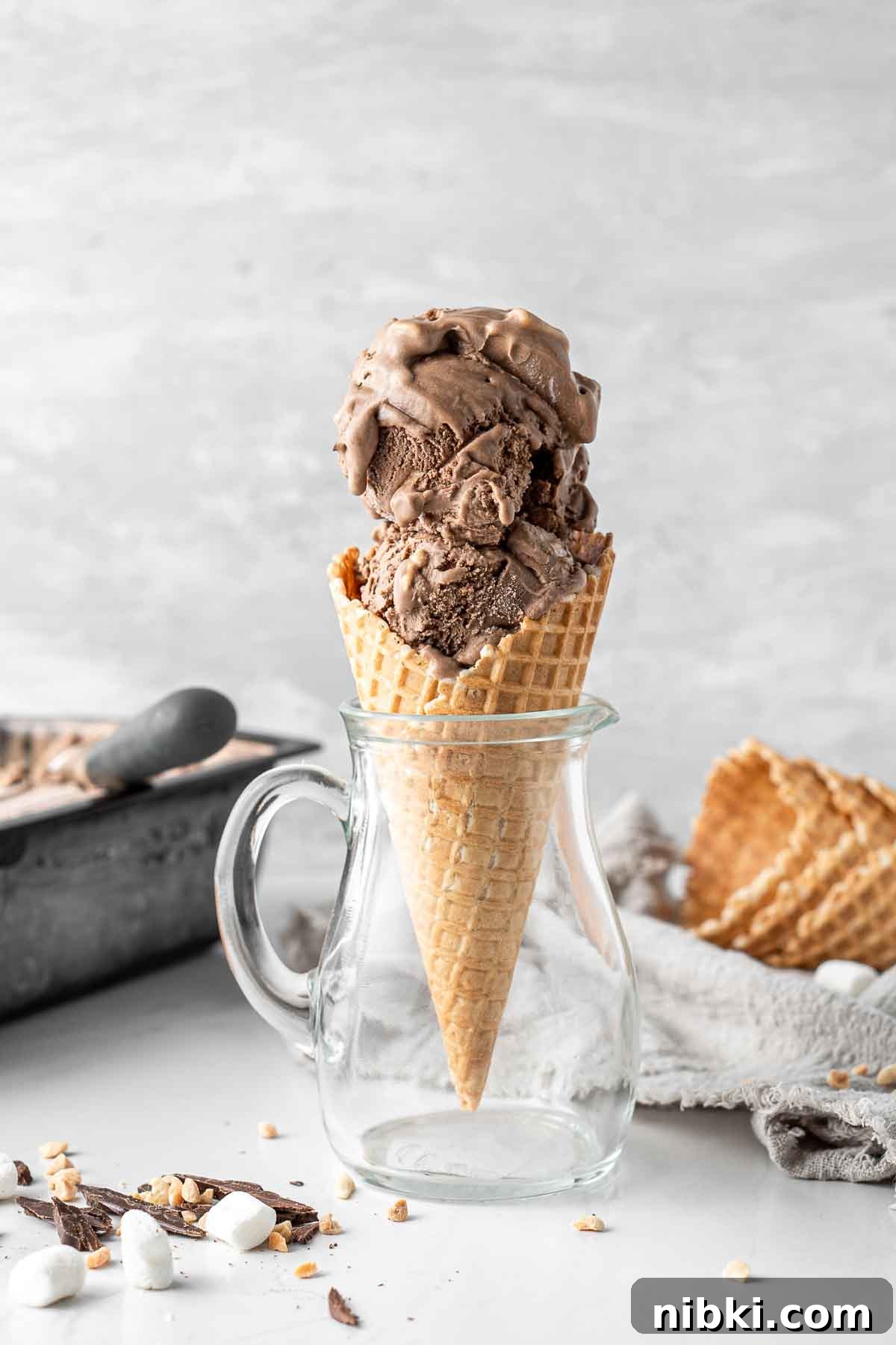 Rocky road ice cream in a cone.