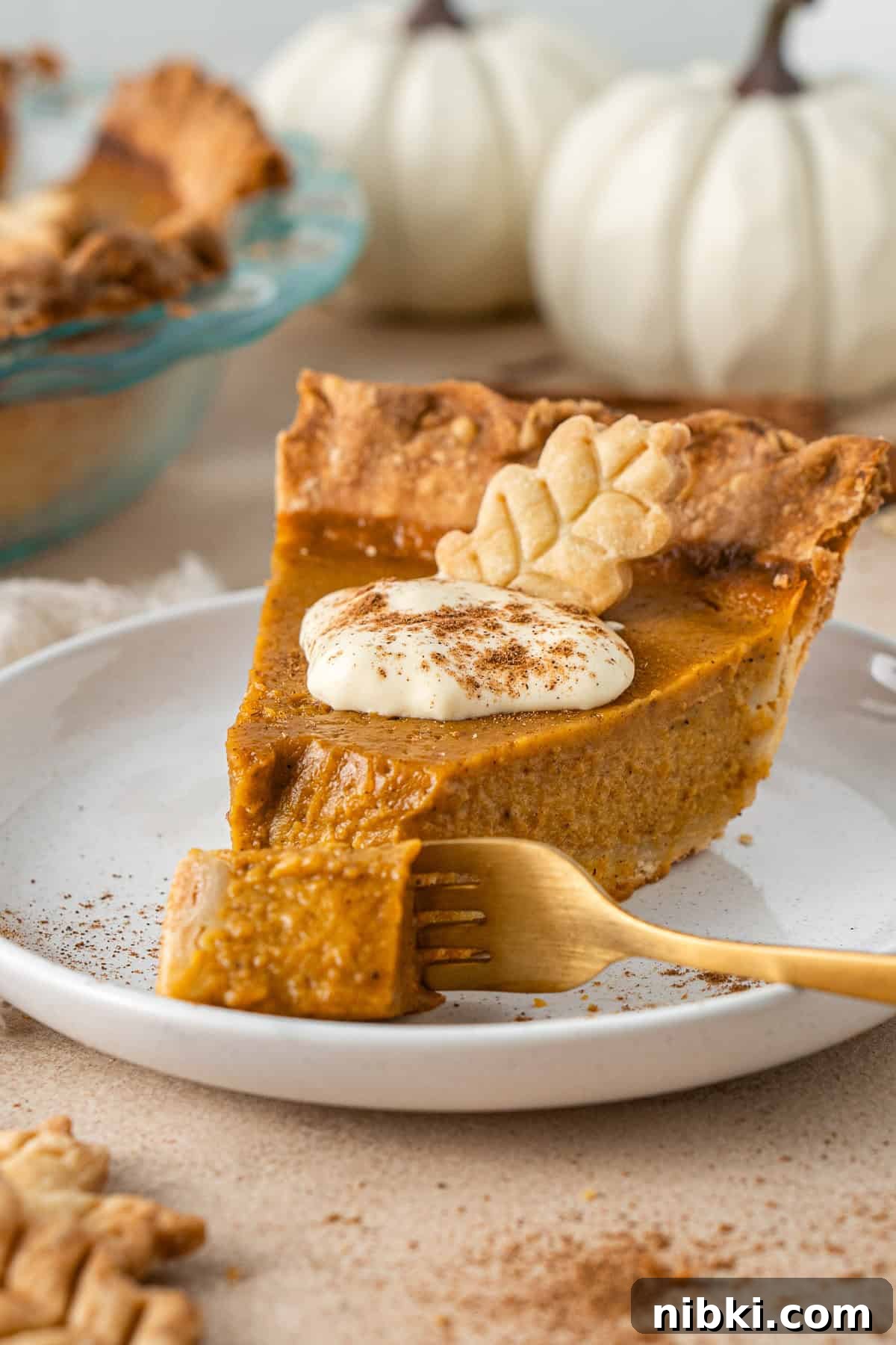A slice of pumpkin pie with a bite taken.