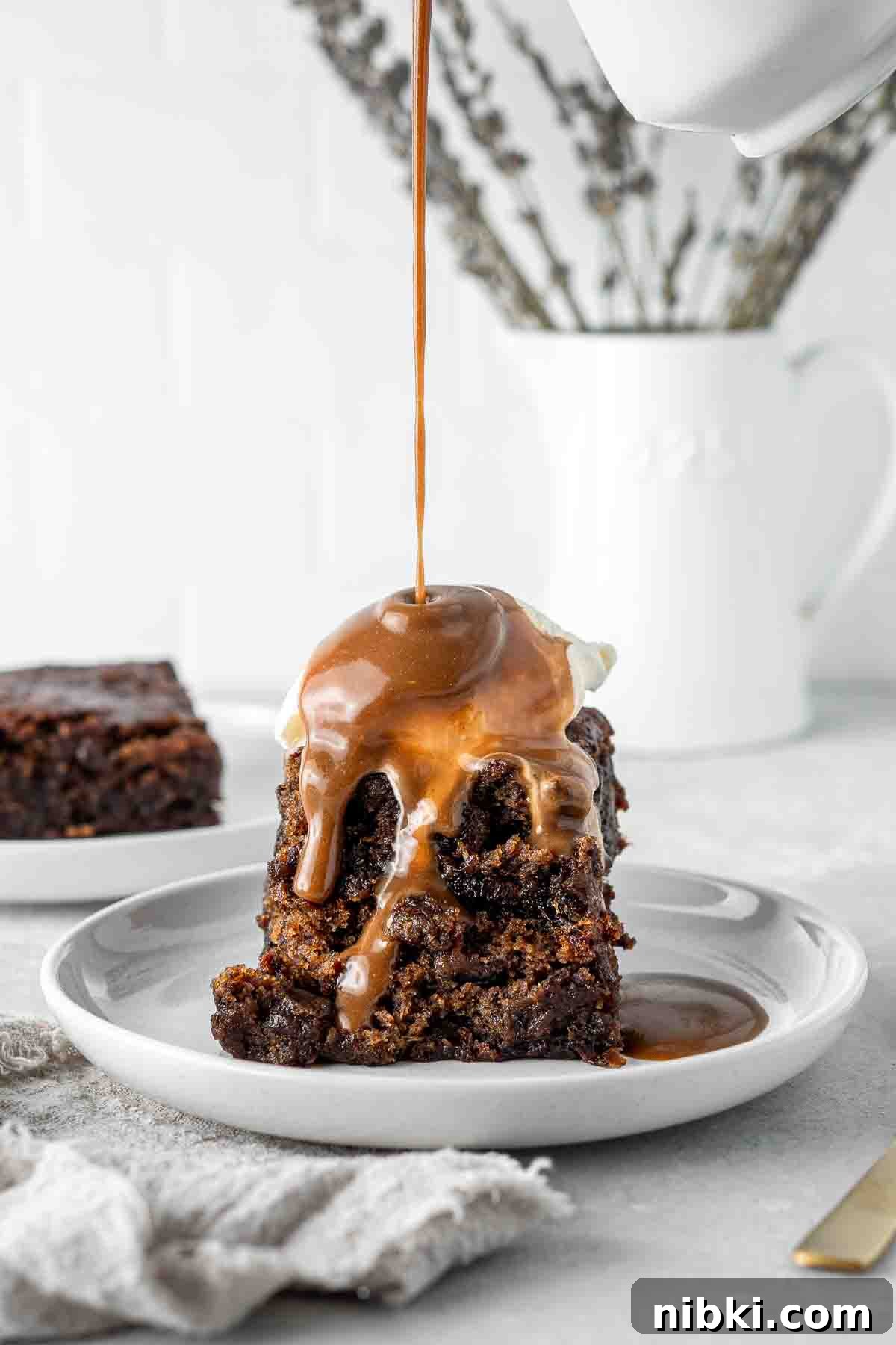 Carmel sauce dripping on sticky date pudding.