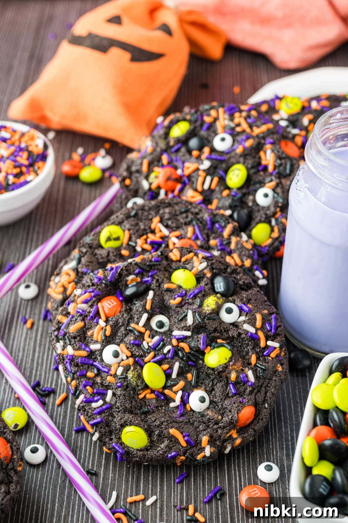 Spooky Halloween Cookie Recipes and Decorating Ideas 6 The cookies on a dark surface with decor.