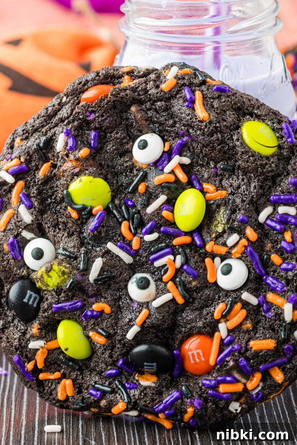 Spooky Halloween Cookie Recipes and Decorating Ideas 7 A cookie with a glass of purple milk behind it.
