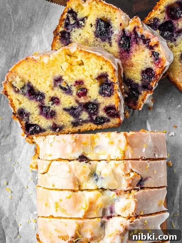 Lemon blueberry loaf slices with lemon icing.