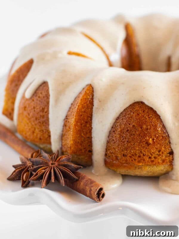 A finished spice bundt cake on a white plate.