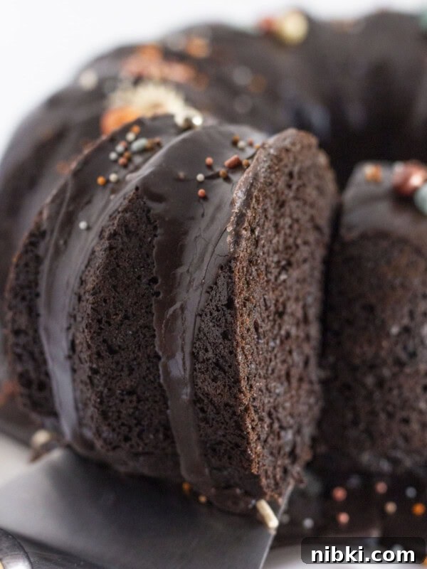 A black velvet cake made with a cake mix with a piece being cut & served.