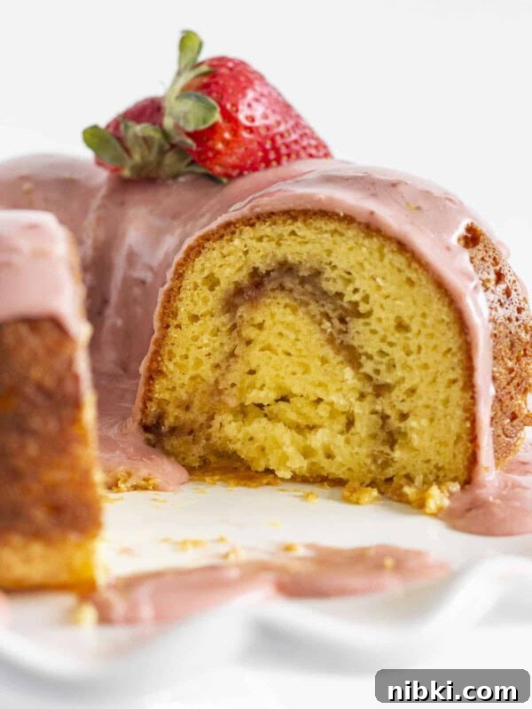 Looking inside at the strawberry swirl of this Strawberry Lemonade Bundt Cake.