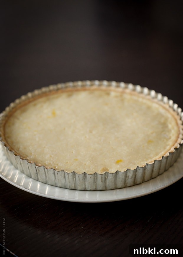 Coconut Custard Tart with Chocolate Ganache Recipe 2 A pie crust baked into a tart pan.