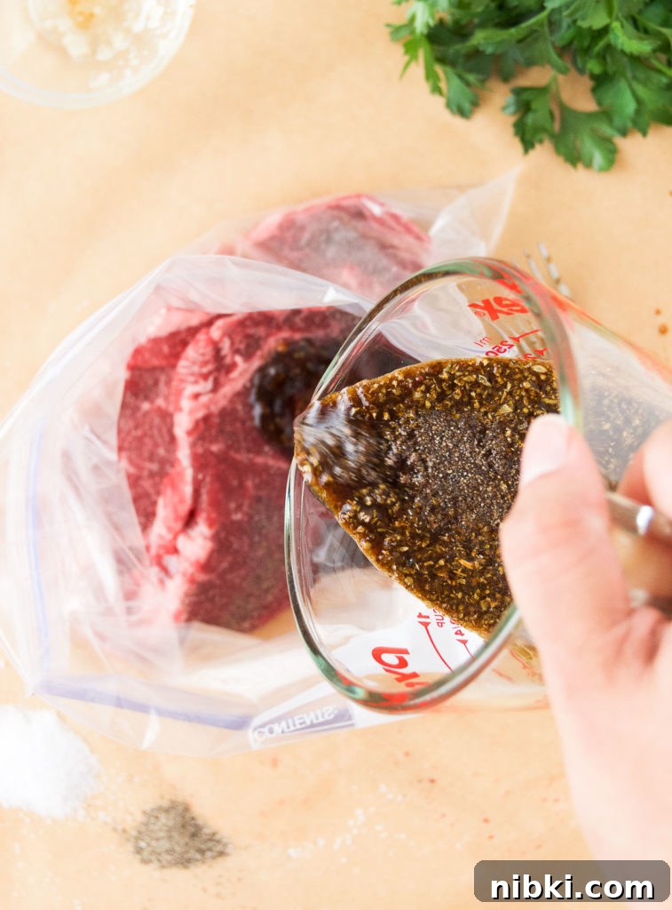 Garlic Herb Ribeye Steak Marinade for Grilling 6 Marinade pours over steaks in a plastic bag