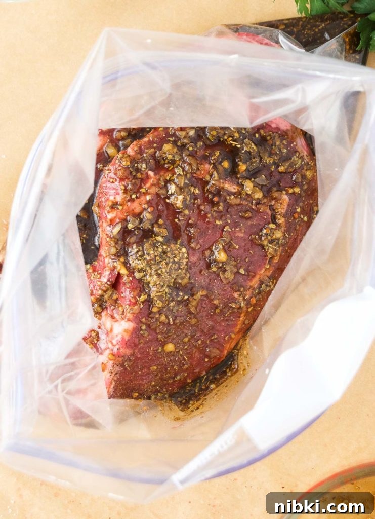 Garlic Herb Ribeye Steak Marinade for Grilling 7 Steaks sit in marinade in a plastic bag