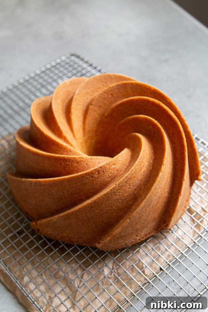 Fragrant Orange Blossom Bundt Cake with Citrus Glaze 8 Orange Blossom Bundt Cake cooling on wire rack.