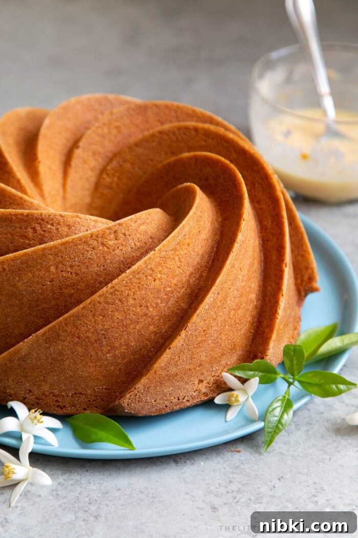 Fragrant Orange Blossom Bundt Cake with Citrus Glaze 9 Orange blossom bundt cake on blue serving plate before glazing.
