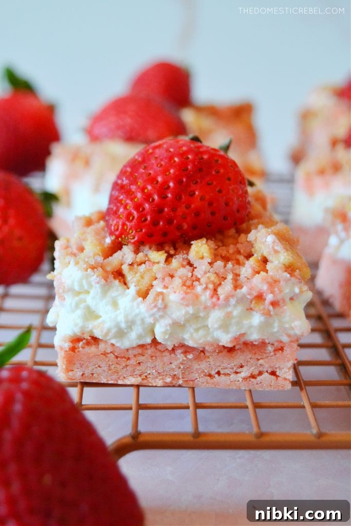 a closeup of a strawberry shortcake bar on a wire rack