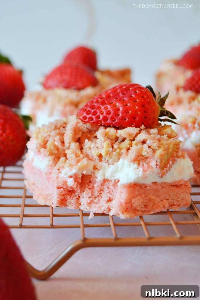a strawberry crunch bar on a wire rack with a bite missing from the bar
