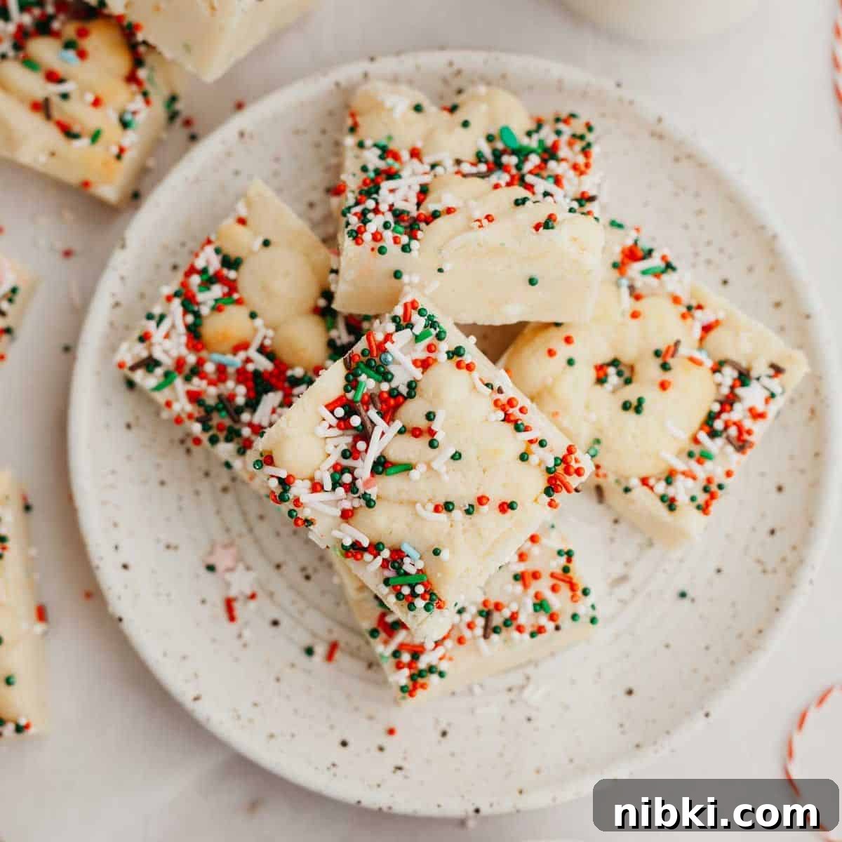A small plate with Christmas cookie fudge pieces on it.