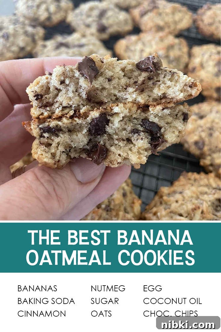 Pinterest picture of banana oatmeal chocolate chip cookies on a cooling rack with a broken in half cookie held above. The text of the ingredients is at the bottom, and the text of the title is right above it.