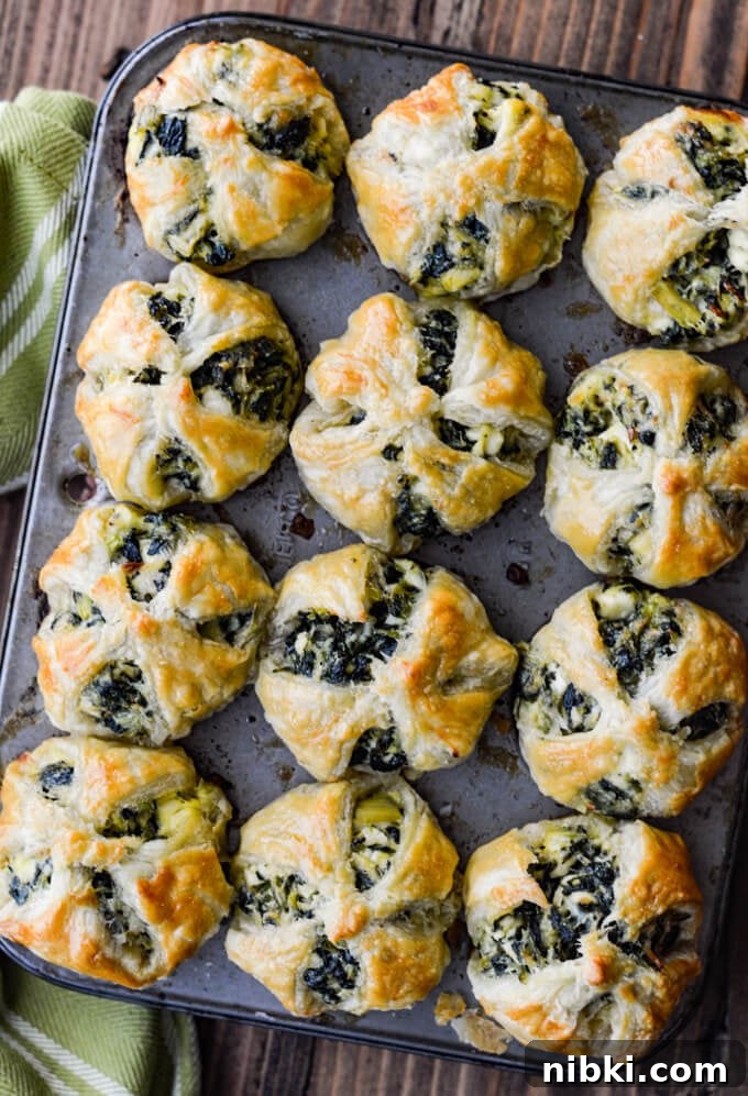 Spinach Puffs Recipe: Flaky Puff Pastry Bites 6 Spinach and Feta Puff Pastry Appetizers in mini muffin tins. A green and white striped napkin sits next to it.