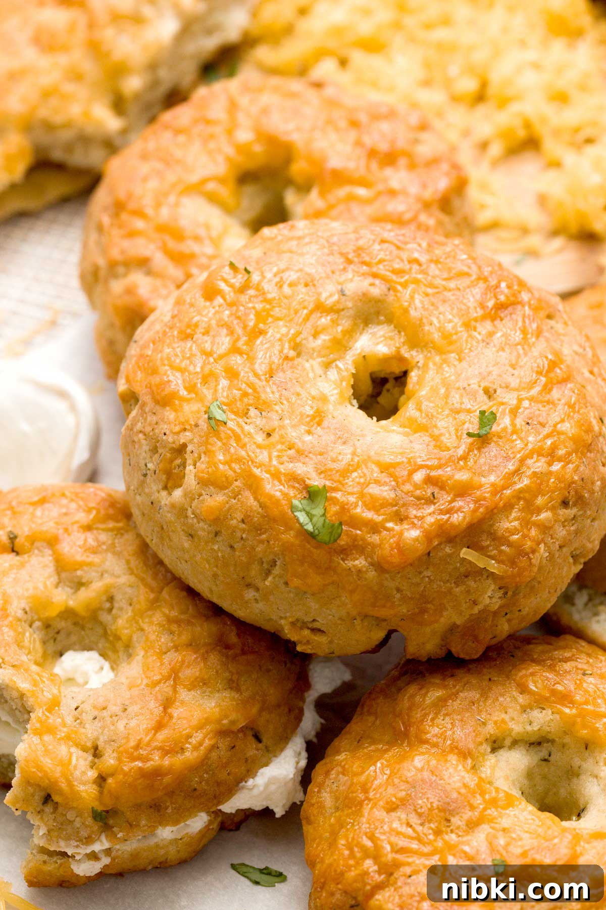 Cheddar Protein Bagels Without Yeast 3 Stack of cheddar cheese bagels.