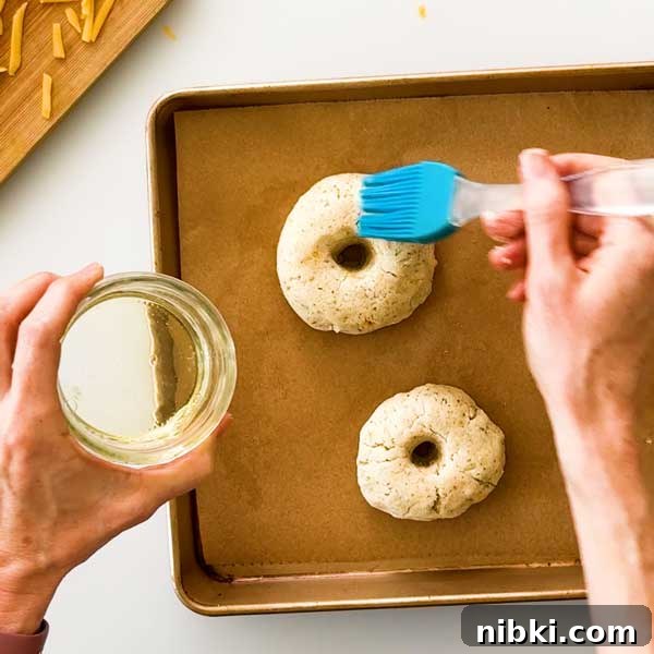 Cheddar Protein Bagels Without Yeast 7 Adding egg wash to the bagels.