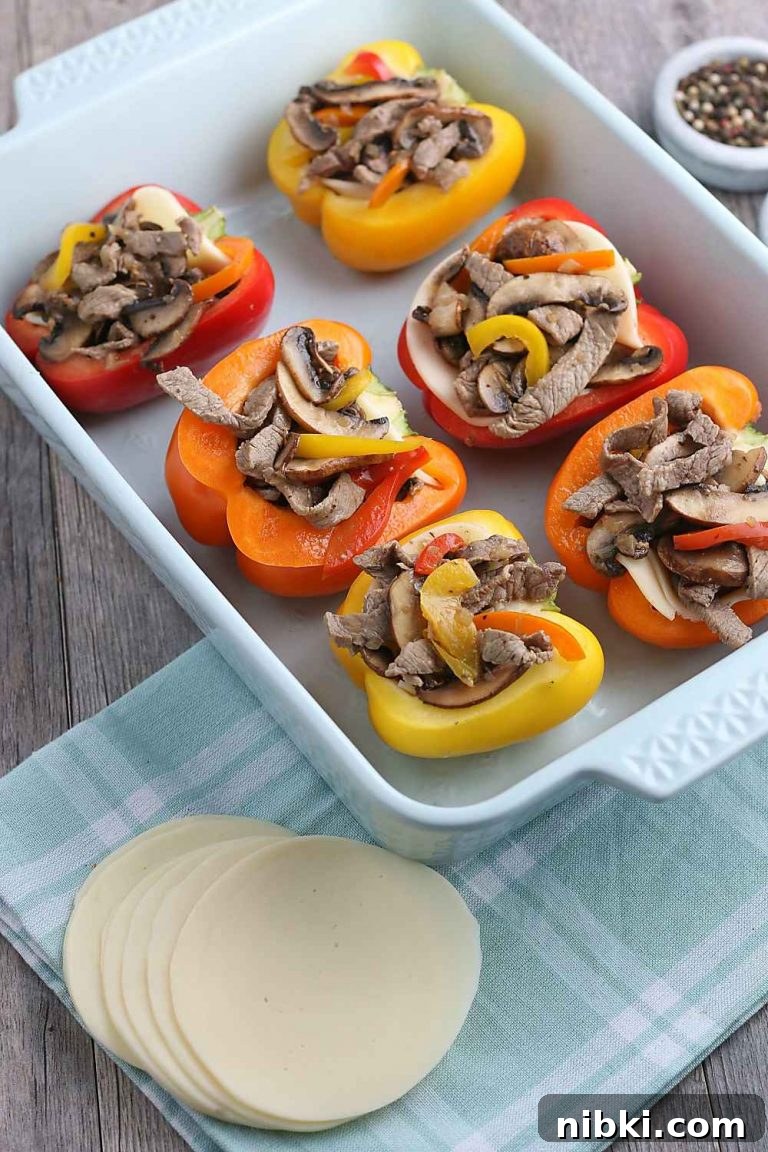 Philly Cheesesteak Stuffed Peppers - Low-Carb, Gluten-Free 4 Now the filling for our stuffed peppers is added to the peppers in a pan, ready to be topped with cheese and baked.