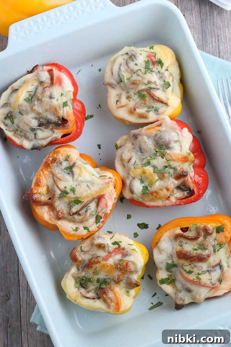 Philly Cheesesteak Stuffed Peppers - Low-Carb, Gluten-Free 7 This image shows the finished stuffed peppers in a pan fresh from the oven. top down shot of the finished cheesesteak stuffed peppers in a pan ready to be served.
