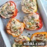 Philly Cheesesteak Stuffed Peppers - Low-Carb, Gluten-Free 8 This image shows the finished stuffed peppers in a pan fresh from the oven. top down shot of the finished cheesesteak stuffed peppers in a pan ready to be served.