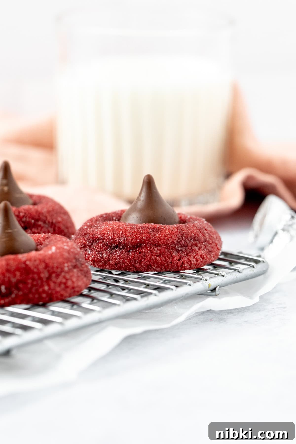 Red Velvet Blossom Bouquet Ideas for Weddings and Gifts 2 Red velvet Hershey's Kiss cookies on a cooling rack with a glass of milk