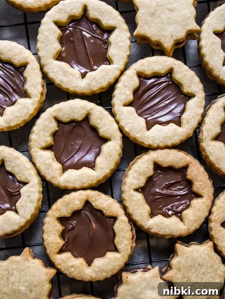 Nutella-Filled Linzer Cookies Recipe 9 filled Nutella Linzer cookies on wire rack (2)