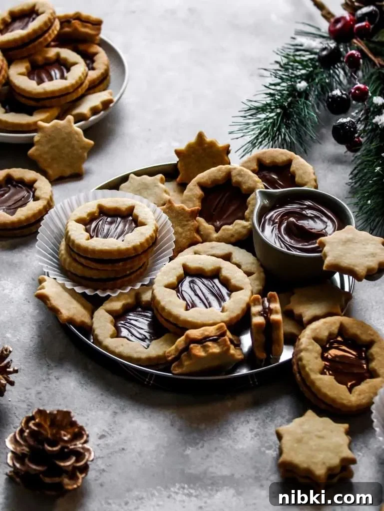 Nutella-Filled Linzer Cookies Recipe 10 filled Nutella Linzer cookies on serving platter (11)
