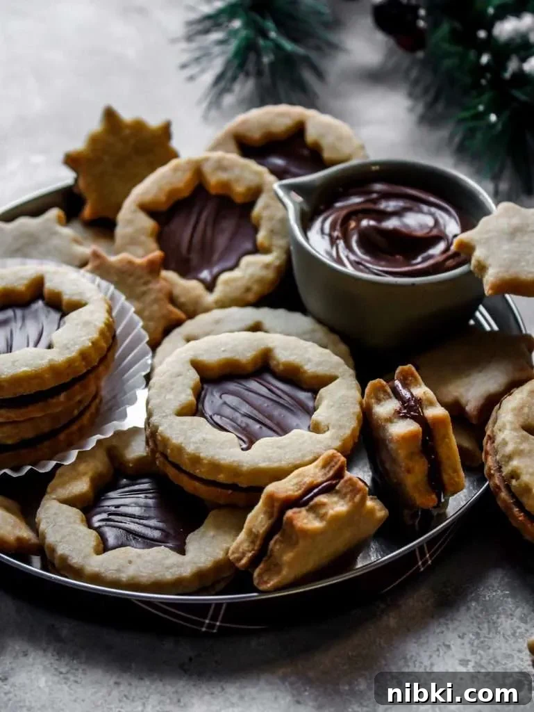Nutella-Filled Linzer Cookies Recipe 12 filled Nutella Linzer cookies on serving platter (1)