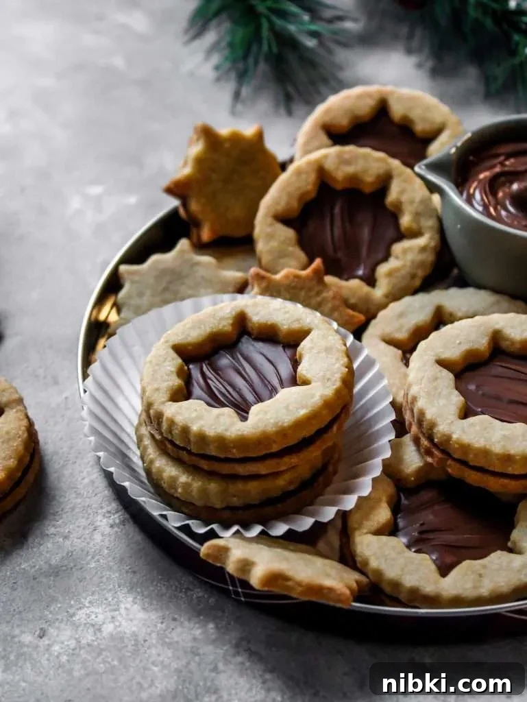 Nutella-Filled Linzer Cookies Recipe 5 filled Nutella Linzer cookies on serving platter (2)